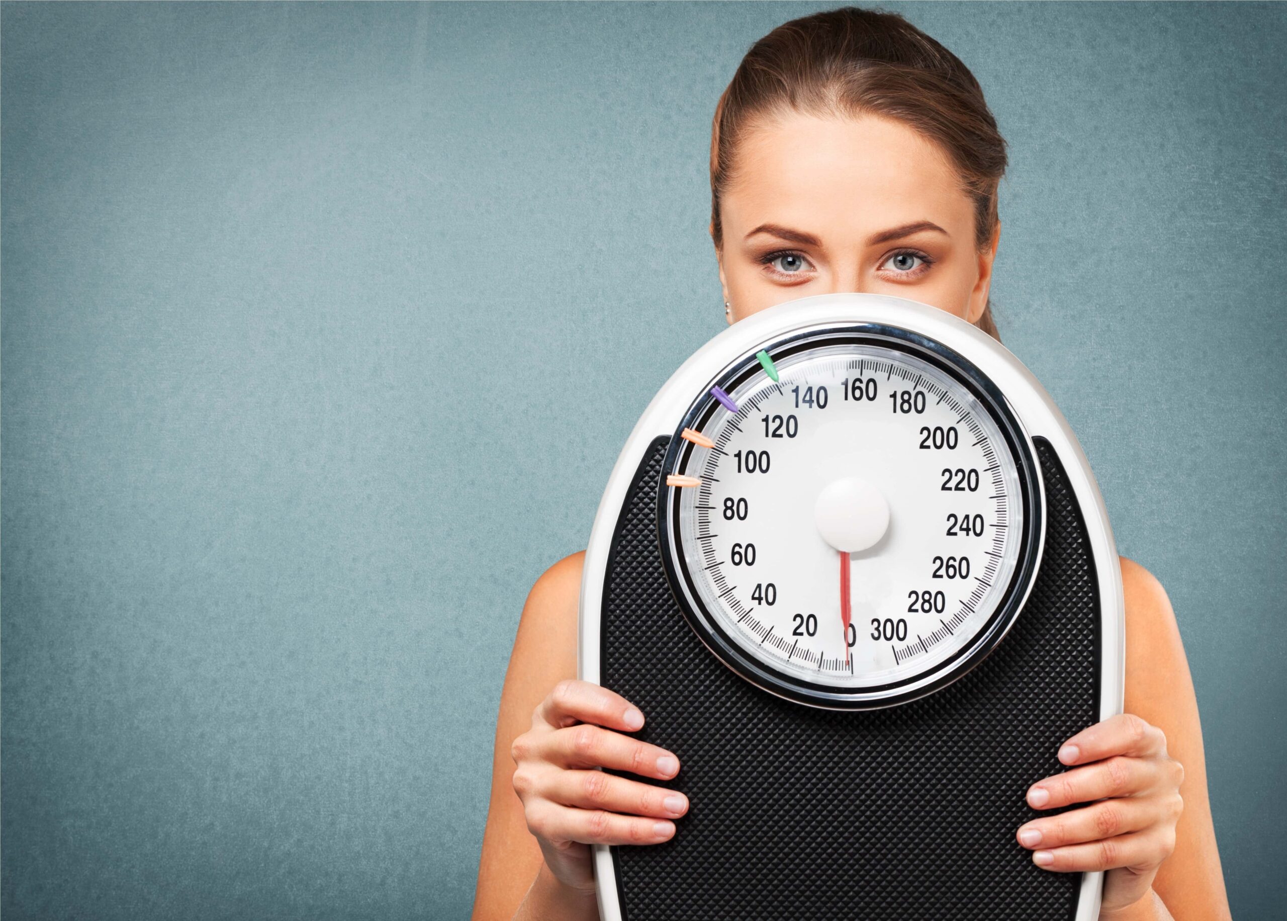 Woman Holding Scale | Fighting Arts Health Lab