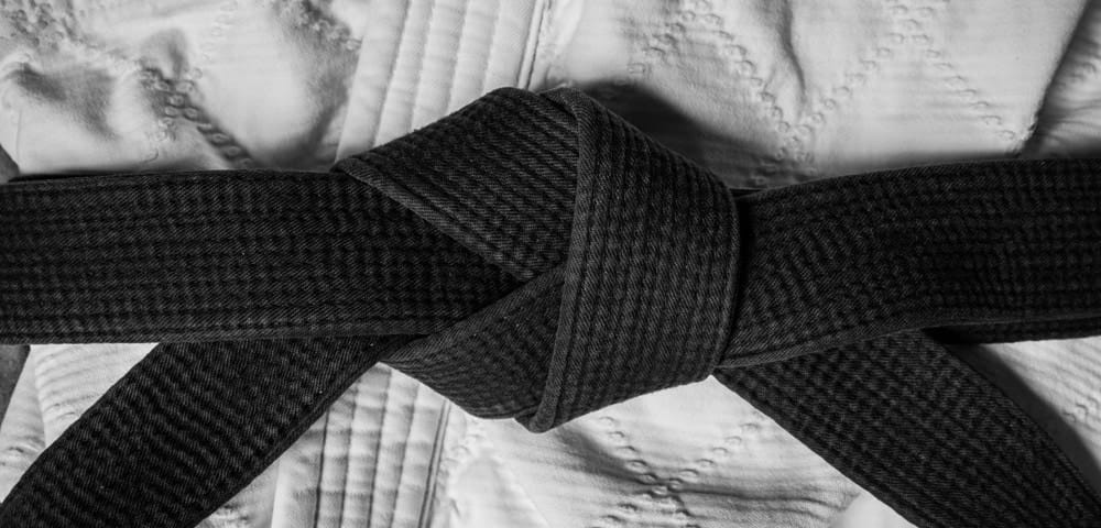 Aikido practitioners ties on black belt Aikido practitioners ties on black belt