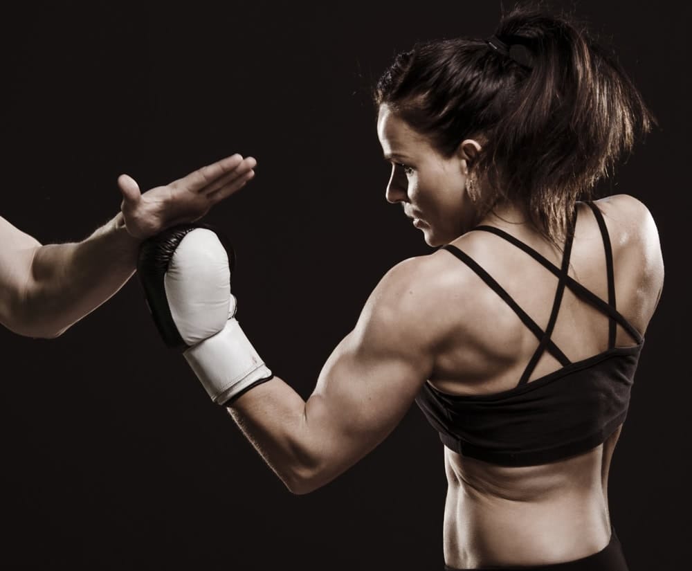 Professional fighter demonstrating core mixed martial arts training techniques Professional fighter demonstrating core mixed martial arts training techniques
