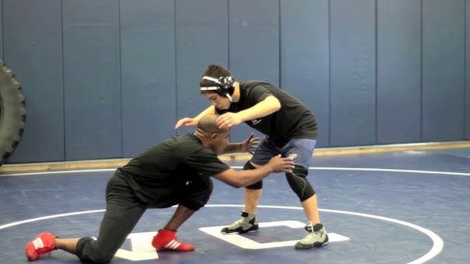Coach Creighton demonstrating wrestling double leg takedown