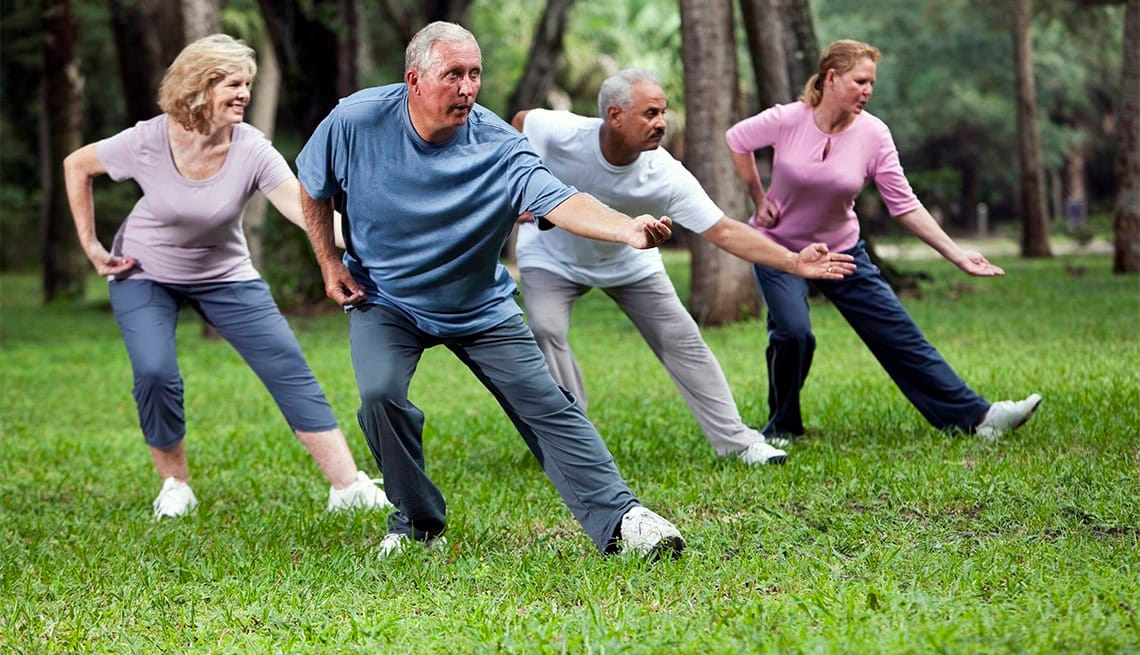 Senior martial arts practitioner demonstrating graceful Tai Chi movements in a park setting with proper form and balance Senior martial arts practitioner demonstrating graceful Tai Chi movements in a park setting with proper form and balance