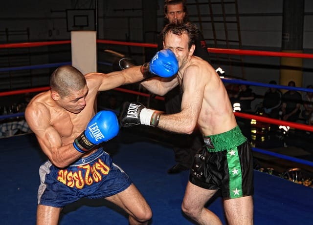 Muay Thai fighter demonstrating punch and knee strikes - the eight-limb striking system from Thailand Muay Thai fighter demonstrating punch and knee strikes - the eight-limb striking system from Thailand